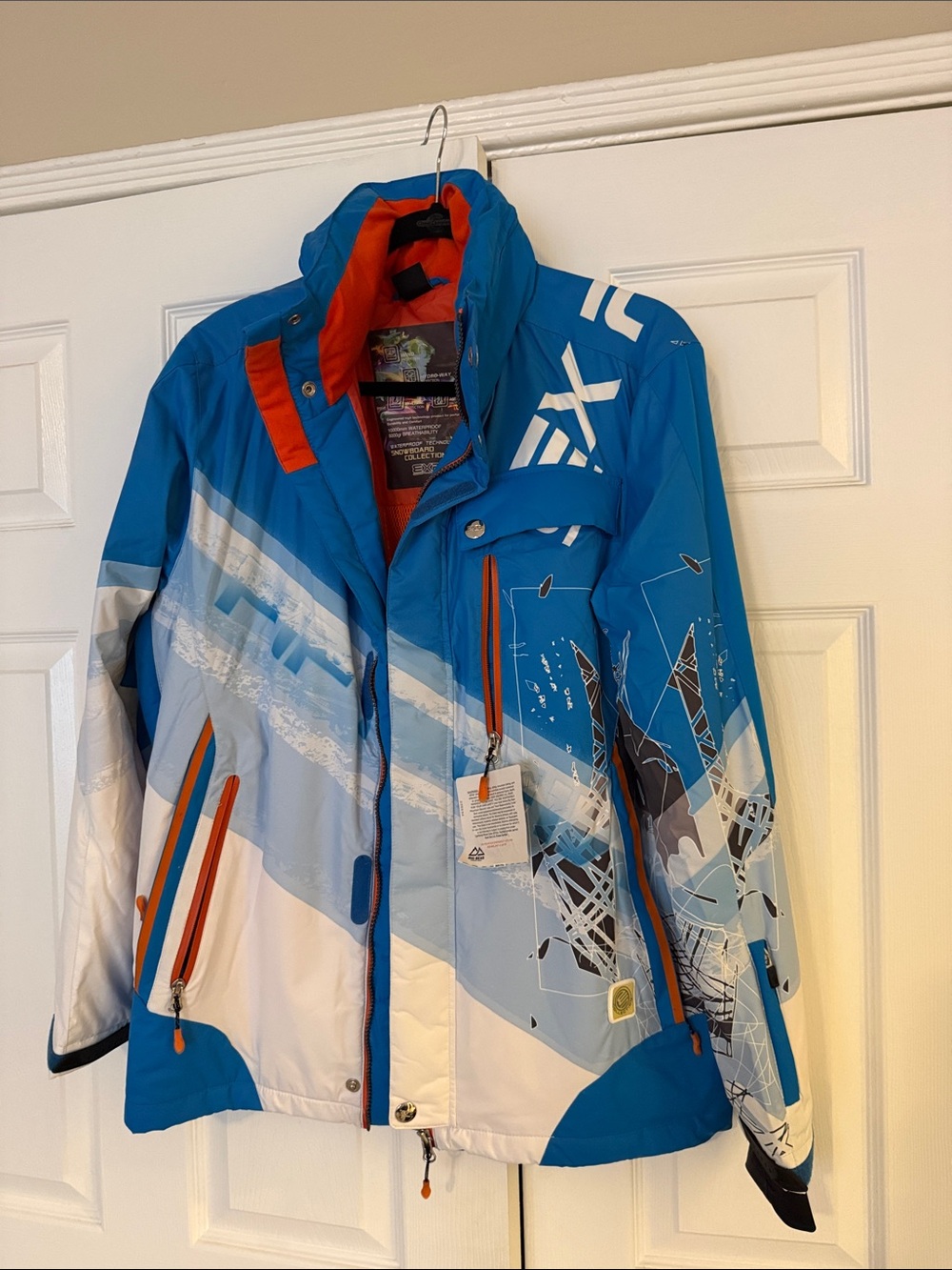 Blue & White Graphic Ski Jacket with Orange Accents